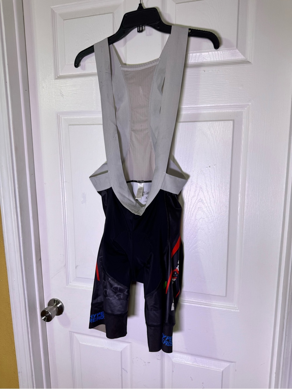 Men's Black Athletic Bib Shorts with Light Gray Straps and Red Accents